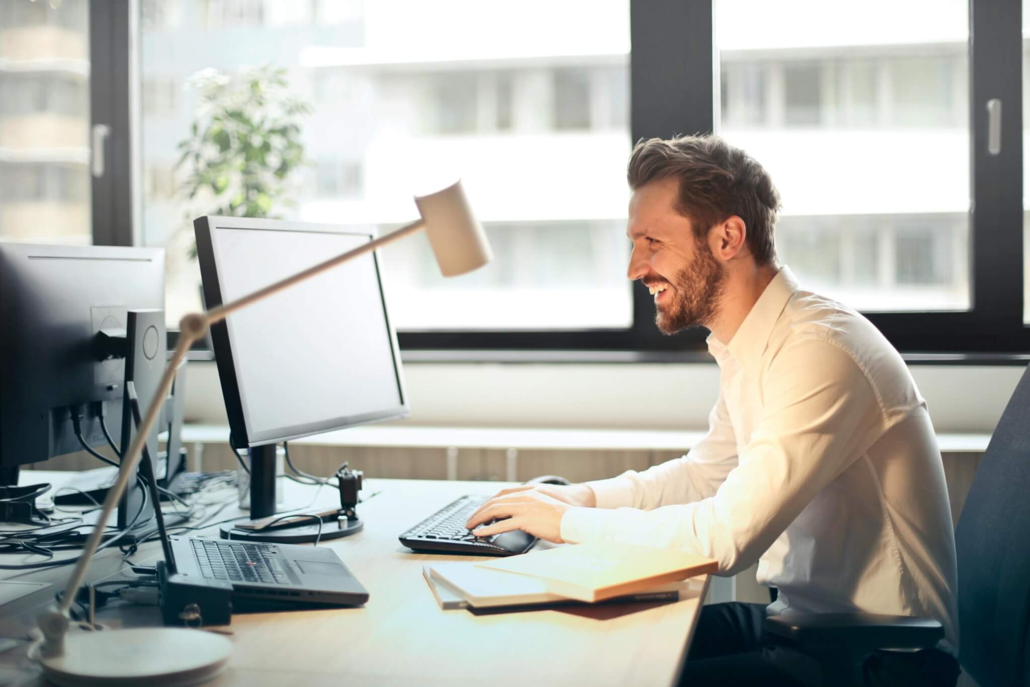 someone sitting at a desk working at their computer