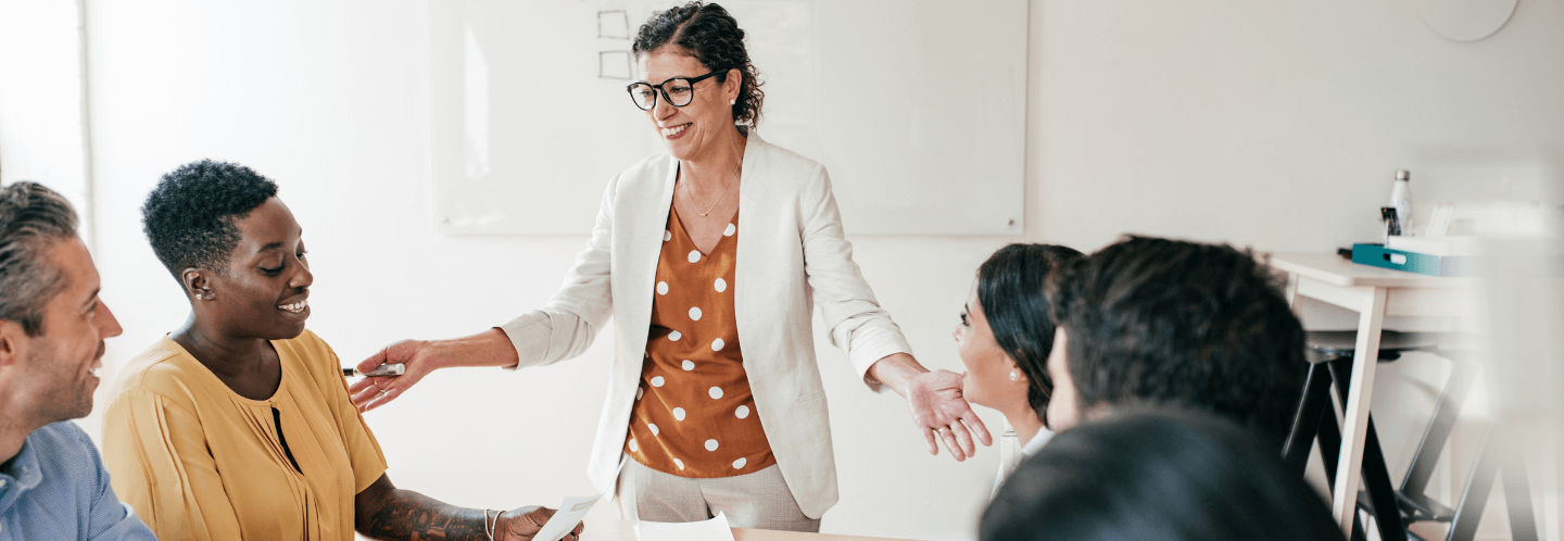 Woman practicing authentic leadership lessons with her team