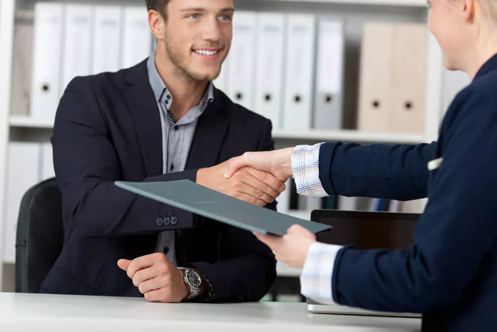 A great salesman shakes hands with another businessman