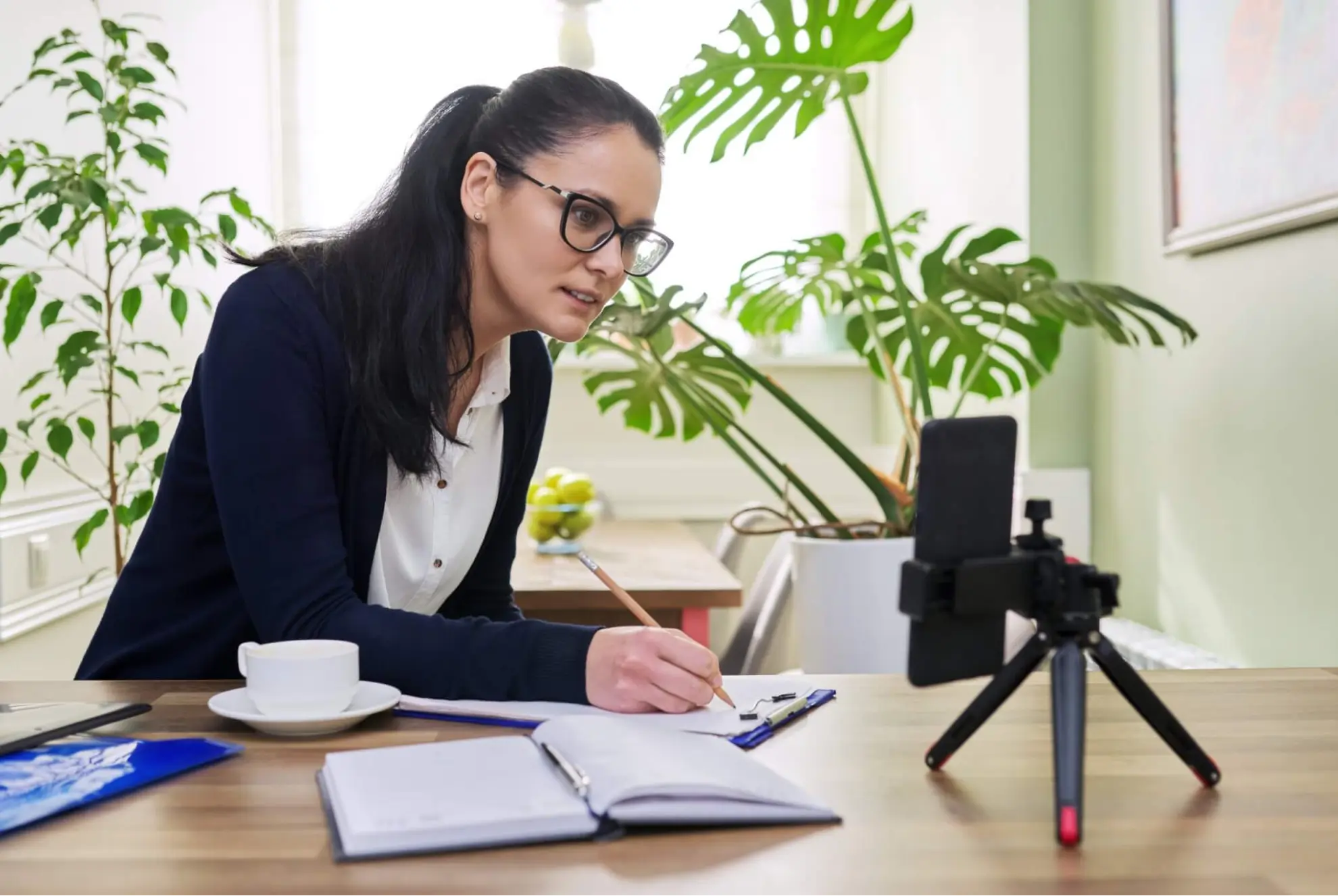 Professional woman wearing glasses participating in an at-home one on one coaching call with Task Human