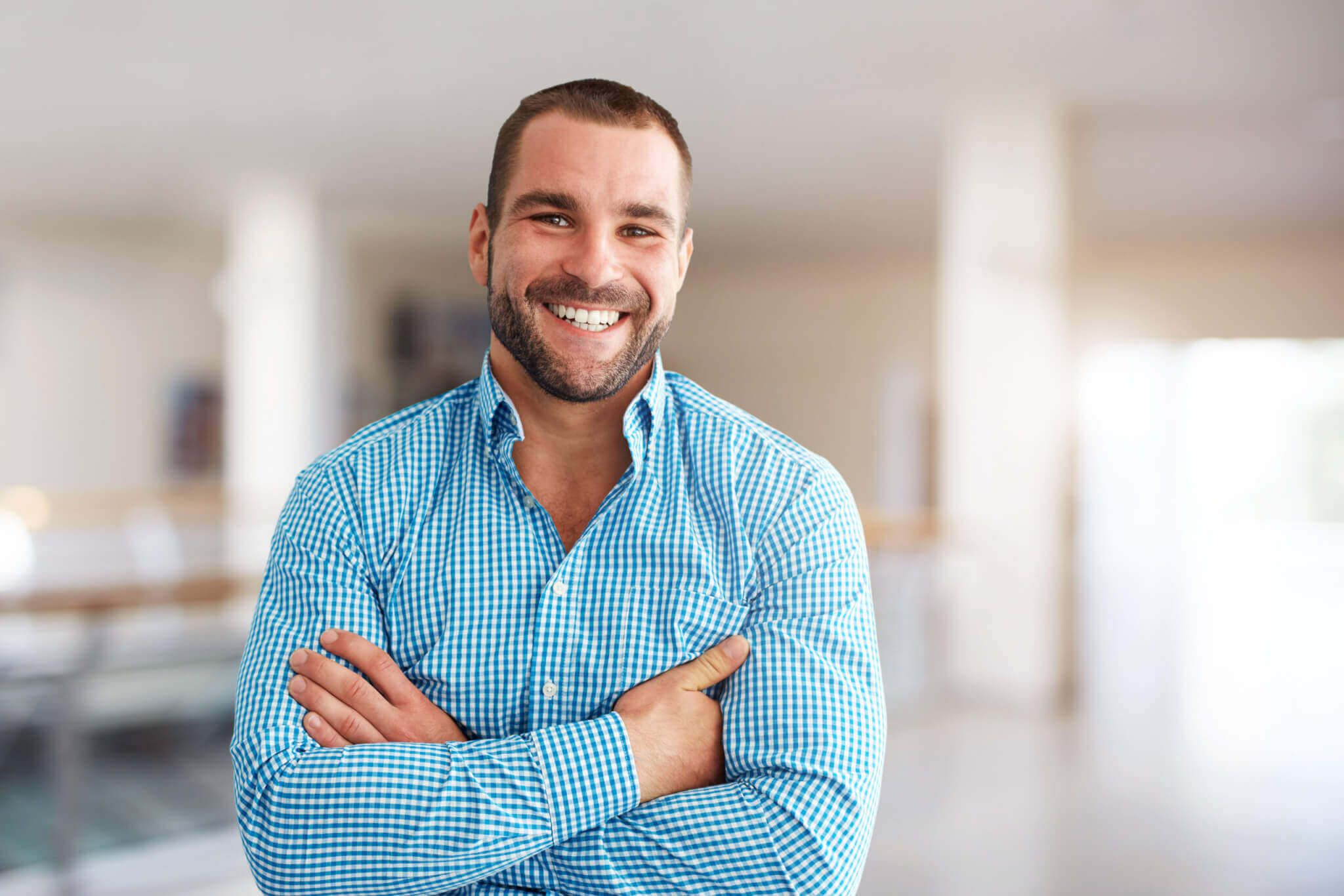 sales-performance-smiling-man-standing-in-business-center