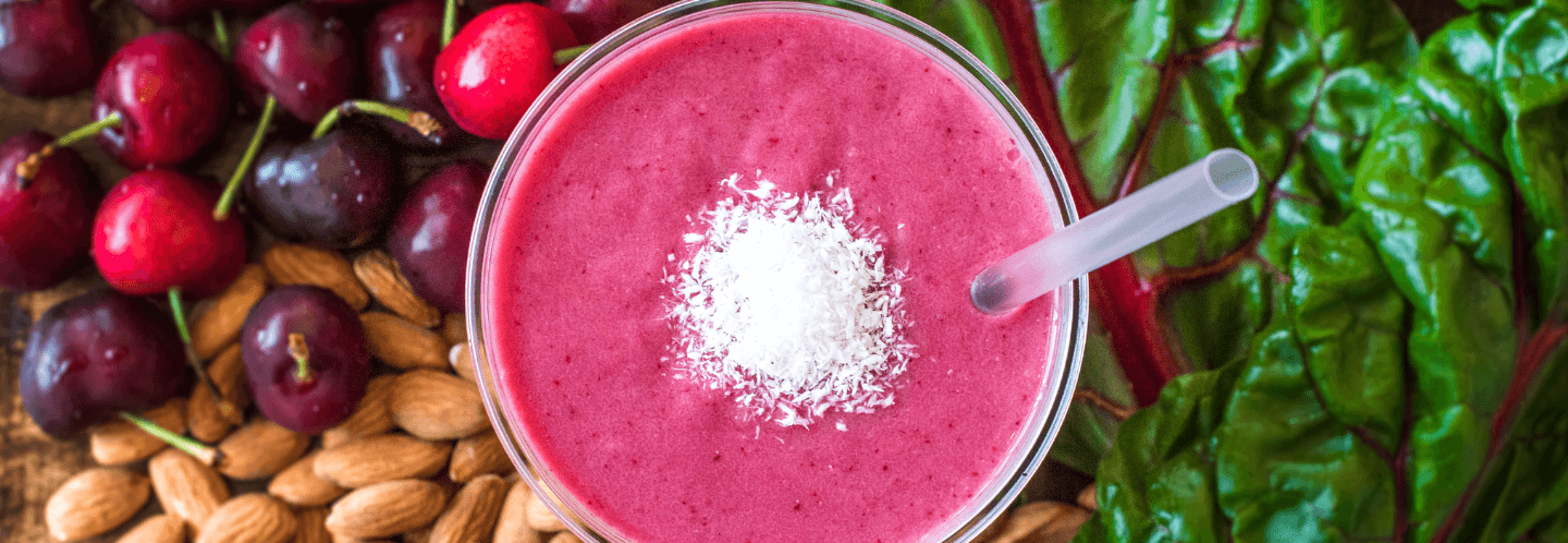 pink smoothie with almonds cherries and kale