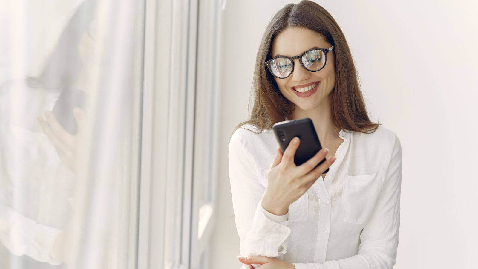 Woman using her phone for on demand coaching through TaskHuman