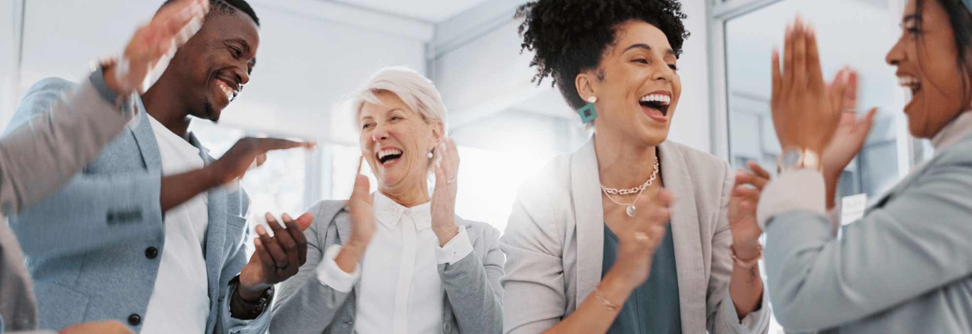 four colleagues laughing