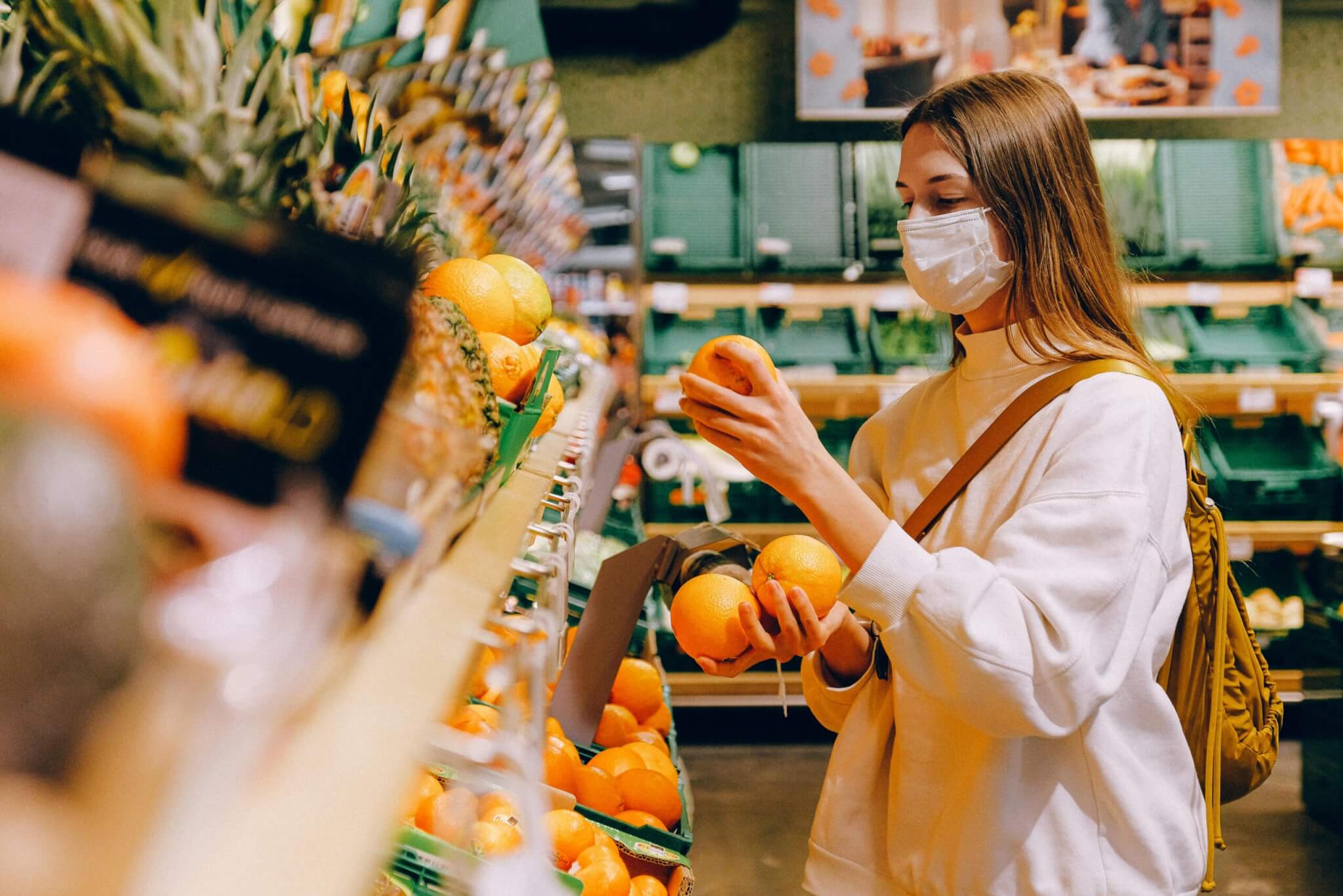 someone looking at produce in a grocery store