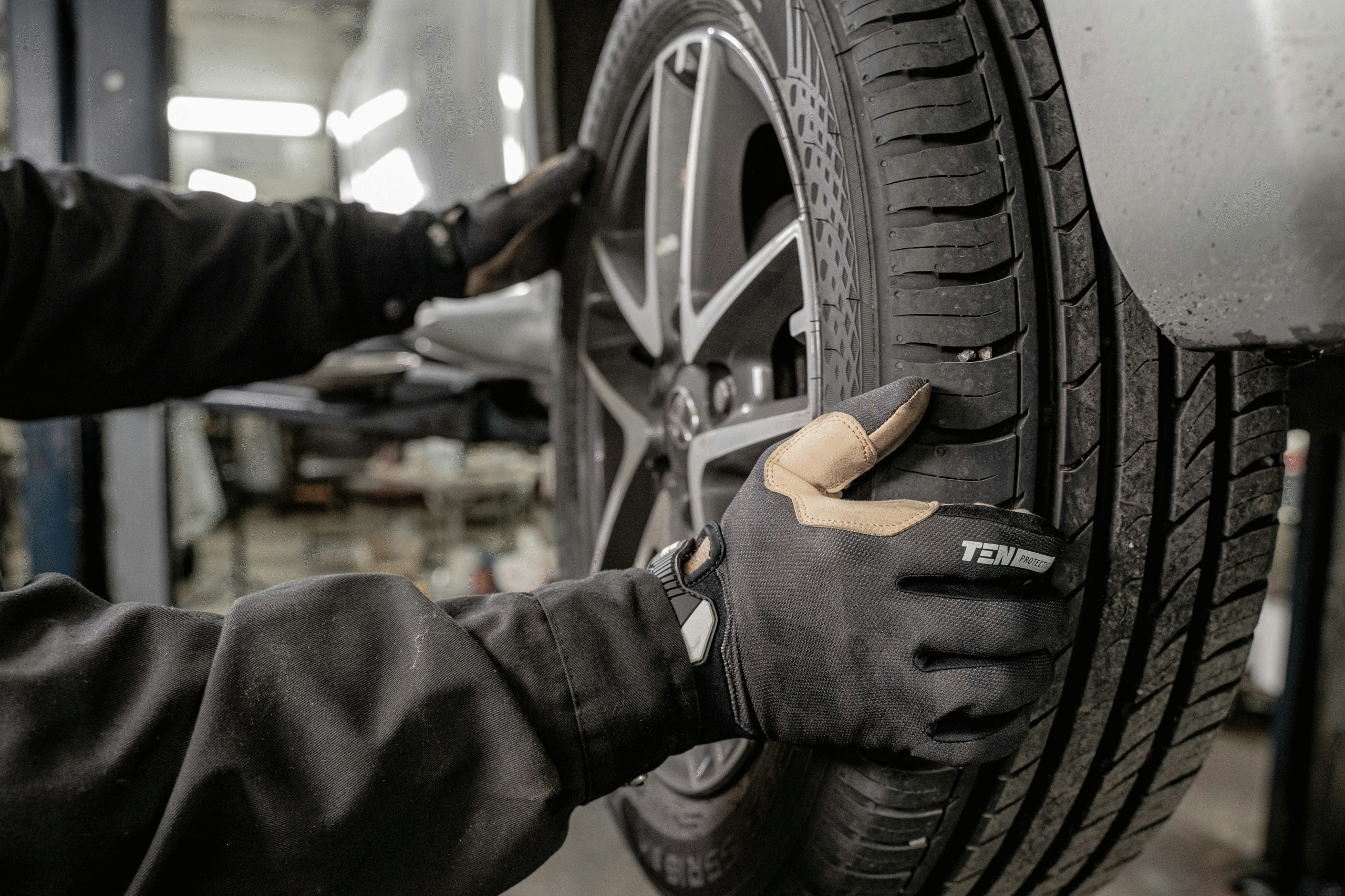 Close-up of technician installing a tire in an auto service center